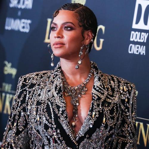 Beyoncé Knowles Pictures Beyonce braless boobs and areola peek showing off nice cleavage on the red carpet for the premiere of The Lion King .