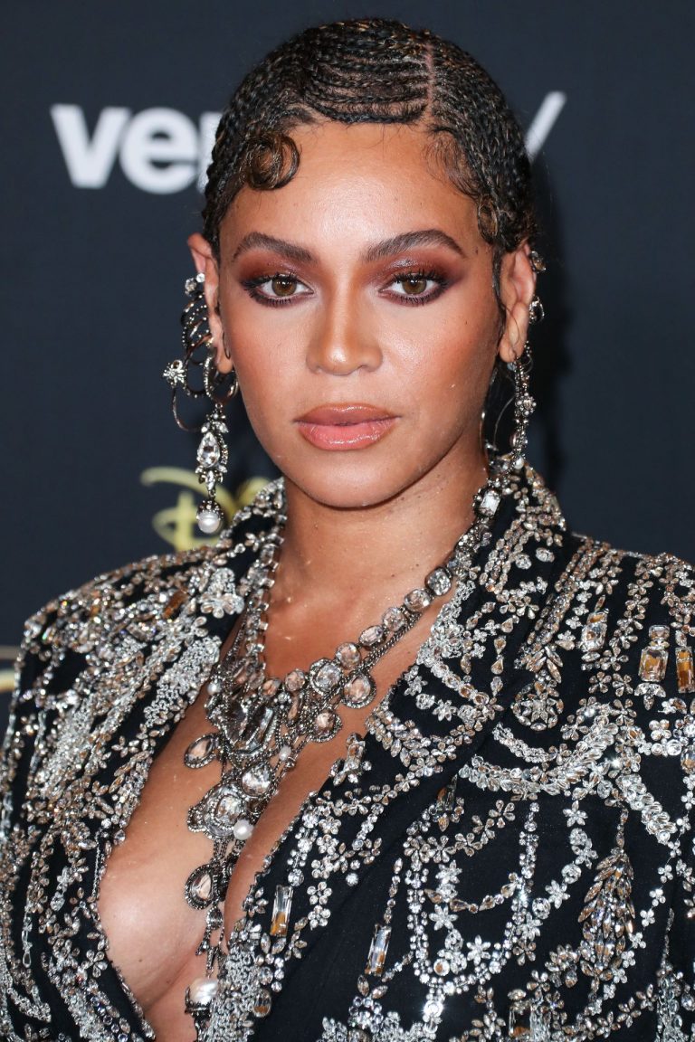 Beyoncé Knowles Pictures Beyonce braless boobs and areola peek showing off nice cleavage on the red carpet for the premiere of The Lion King .