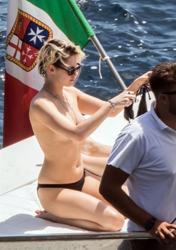 Kristen Stewart nude boobs caught topless by paparazzi tanning on a boat.
