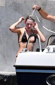 Kristen Stewart nude boobs caught topless by paparazzi tanning on a boat.
