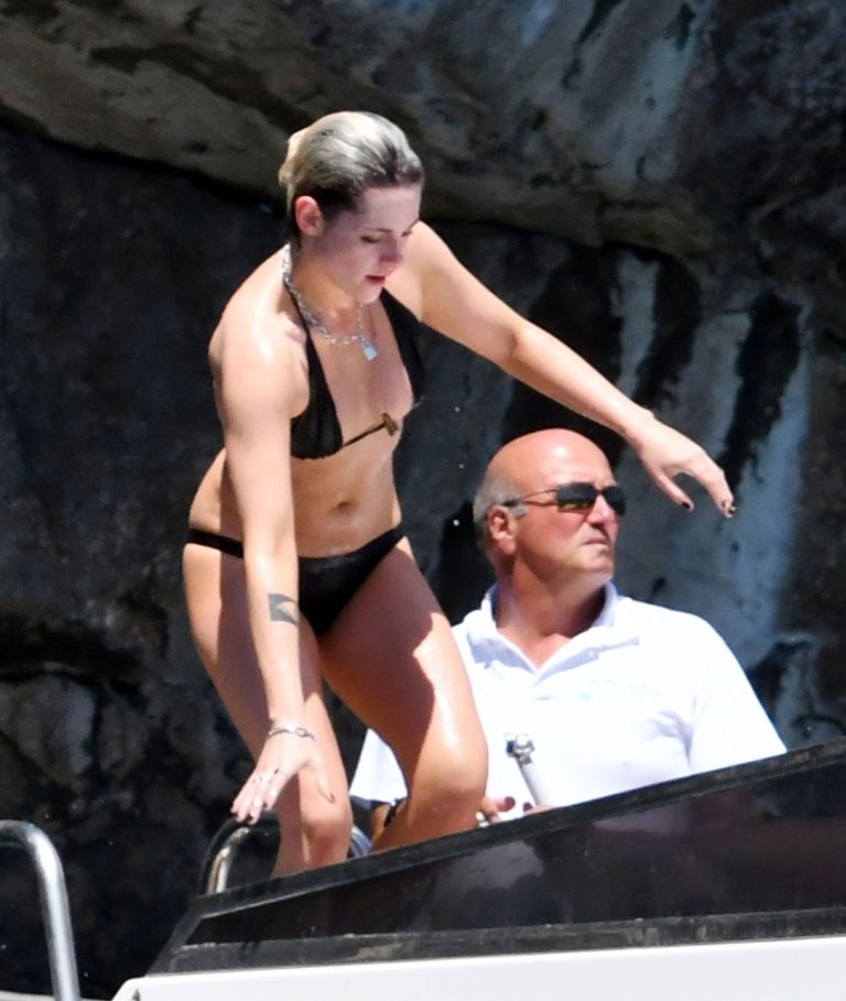 Kristen Stewart nude boobs caught topless by paparazzi tanning on a boat.
