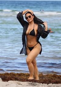 Daphne Joy sexy ass and boobs in a thong bikini at the beach seen by paparazzi showing nice cleavage and booty.
