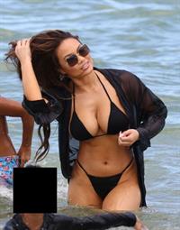 Daphne Joy sexy ass and boobs in a thong bikini at the beach seen by paparazzi showing nice cleavage and booty.
