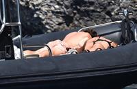 Madalina Diana Ghenea sexy ass and cleavage in a thong bikini seen by paparazzi.



