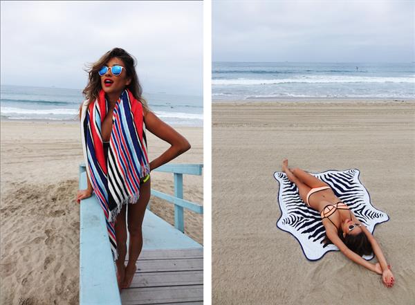 Shay Mitchell at the beach with a surfboard