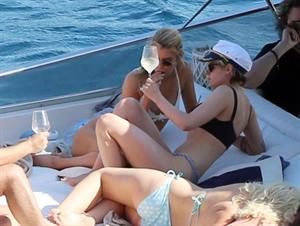 Kristen Stewart and Stella Maxwell sexy lesbians making out on a boat in bikinis seen by paparazzi.










