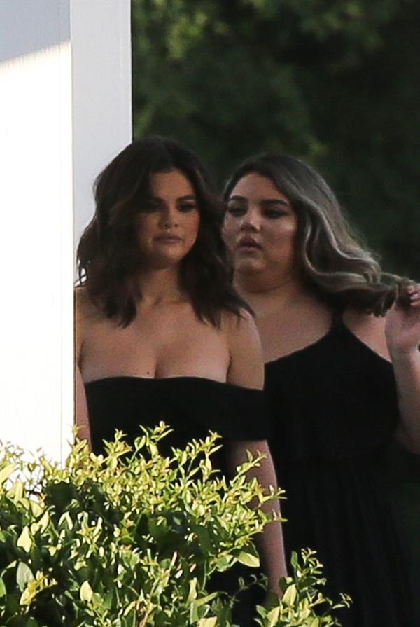 Selena Gomez sexy in a black dress for her cousins wedding showing nice cleavage seen by paparazzi.























