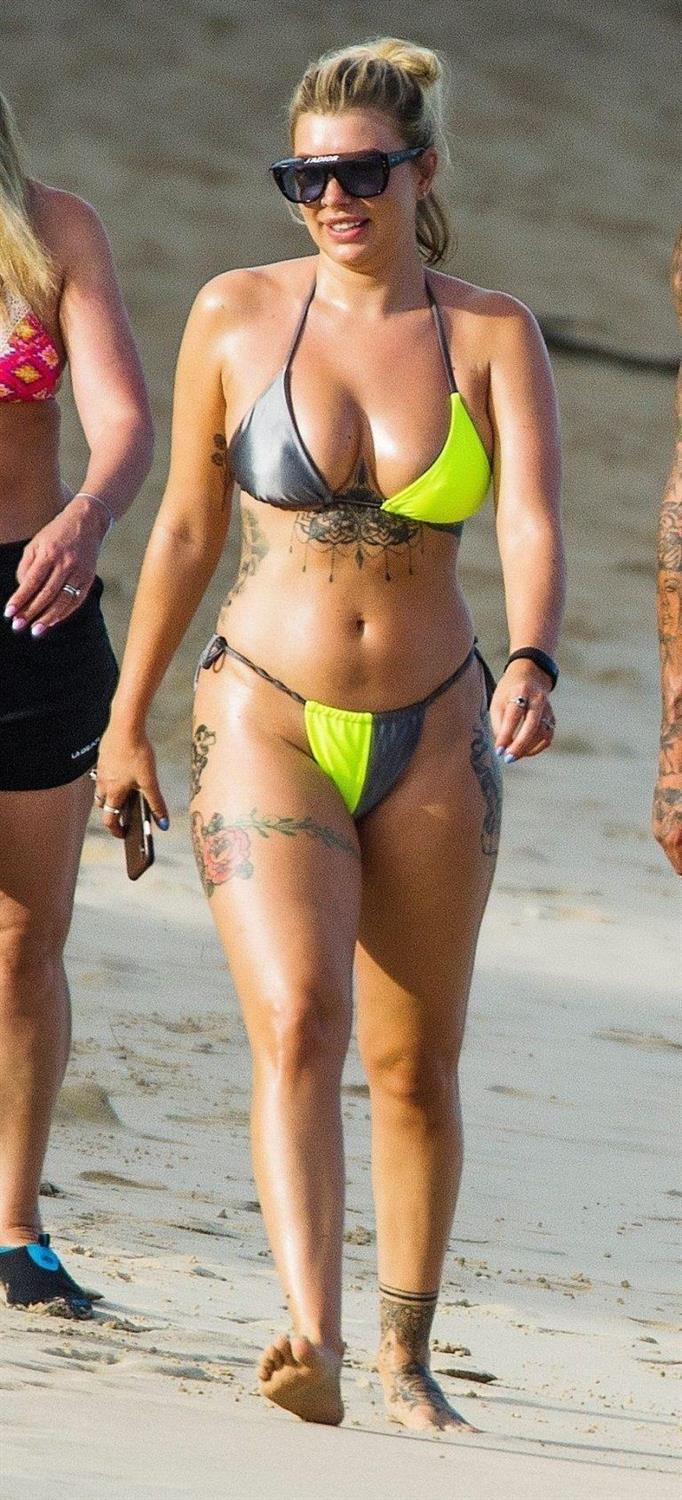 Olivia Buckland sexy in a bikini at the beach seen by paparazzi showing  nice cleavage.