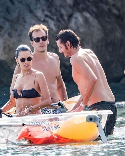 Alessandra Ambrosio Bikini Pictures Alessandra Ambrosio sexy at the beach in a thong bikini and flashing her pussy to her boyfriend seen by paparazzi.