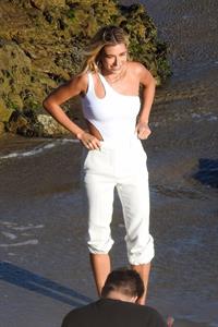 Hailey Bieber braless nipples pokies in a white top at the beach seen by paparazzi during a photo shoot.



















