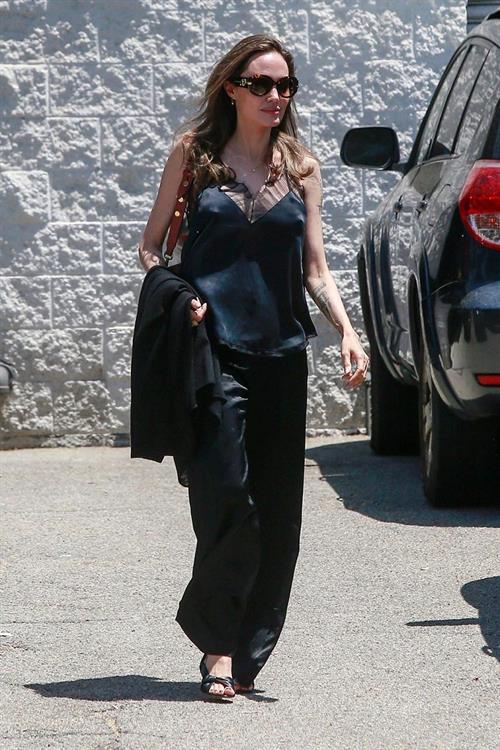 Angelina Jolie Pictures Angelina Jolie braless tits pokies in a black top seen by paparazzi showing her hard nipples.