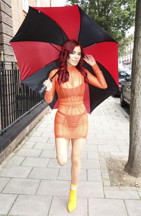 Carla Howe Pictures Carla Howe sexy body in a see through orange dress showing her bra and thong panties seen by paparazzi.