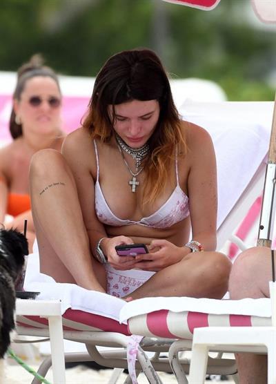 Bella Thorne areola peek in a sexy bikini at the beach seen by paparazzi.




