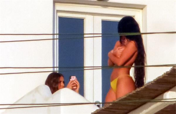 Martha Kalifatidis caught topless by paparazzi with her hand covering her nude big boobs.





