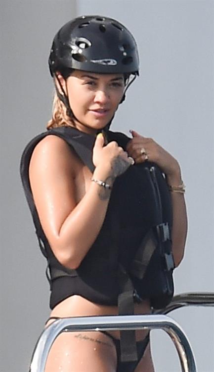 Rita Ora Pictures Rita Ora sexy ass and boobs in a thong bikini showing nice cleavage on a yacht seen by paparazzi.