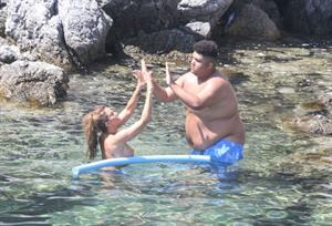 Katie Price caught nude with her son by paparazzi showing her topless boobs.

