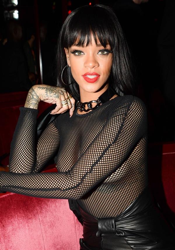 Rihanna braless boobs in a see through fishnet top showing off her tits and pierced nipple.




