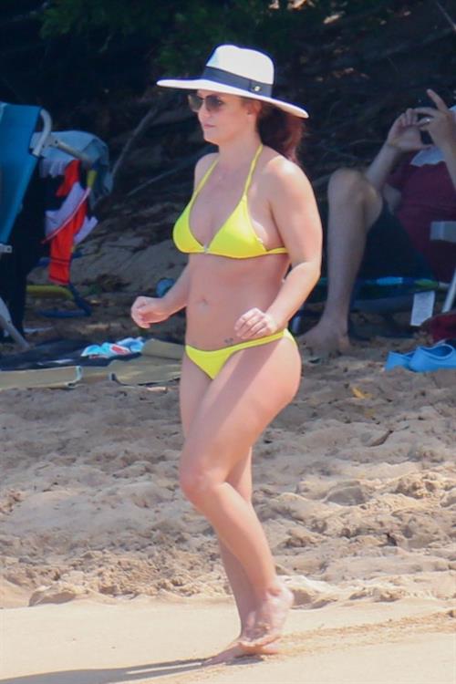 Britney Spears Bikini Pictures Britney Spears in a sexy little yellow bikini seen by paparazzi at the beach showing nice cleavage.