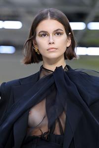 Kaia Gerber nip slip caught with her braless boobs in a see through top modelling on the runway.
































