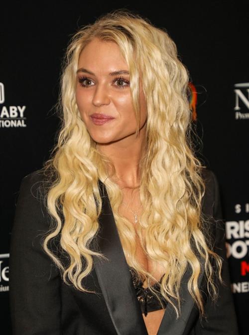 Lucie Donlan Pictures Lucie Donlan big boobs showing nice cleavage in a black bra top with just a low cut jacket over top photographed by paparazzi on the red carpet.