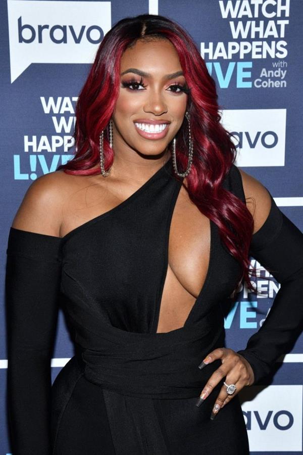 Porsha Williams braless boobs in a revealing black dress showing off her big tits cleavage.
