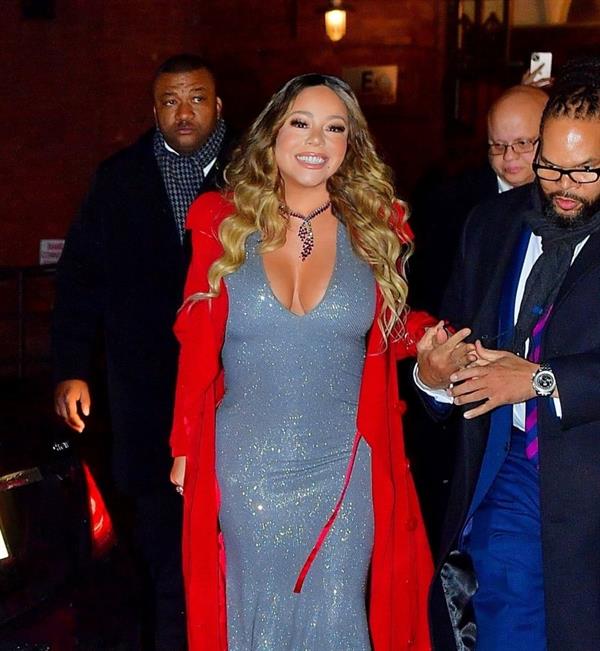 Mariah Carey braless boobs showing nice cleavage with her big tits in a low cut sexy silver dress seen by paparazzi.