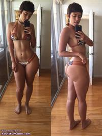 Anonymous in a bikini taking a selfie and - ass