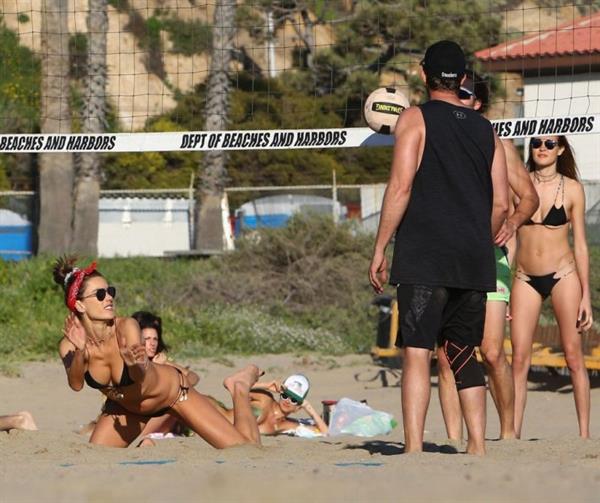 Alessandra Ambrosio sexy ass in a thong bikini also showing nice cleavage playing volleyball on the beach seen by paparazzi.