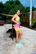 Natalie Porkman is looking fine in a short rainbow dress that she lifts to show off her T&A. This bombshell teen has some fine looking little titties and an always wet bald pussy. Watch her masturbate with her magic fingers even though she's sitting outside where anyone might see her.