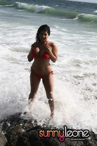 Sunny Leone wearing a red bikini