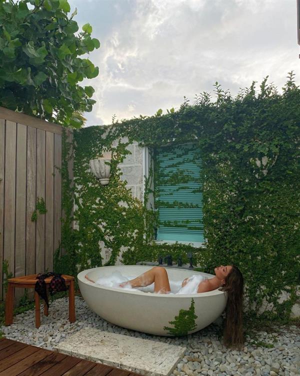 Kylie Jenner naked new photo as she started her morning with an outdoor bubble bath with the bubbles covering her nude big tits.
