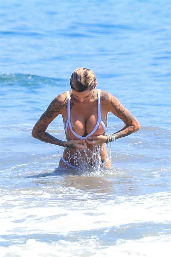 Tina Louise nip slip wardrobe malfunction accidentally flashing her nude big tits in a bikini at the beach seen by paparazzi.