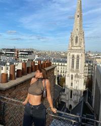 Kylie Jenner boobs in a sexy see through top showing off her big tits posing outside with her hot model body.