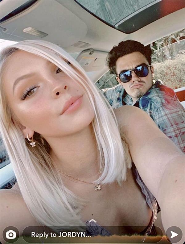 Jordyn Jones tit slip wardrobe malfunction accidentally flashing her braless boobs while leaning forward.