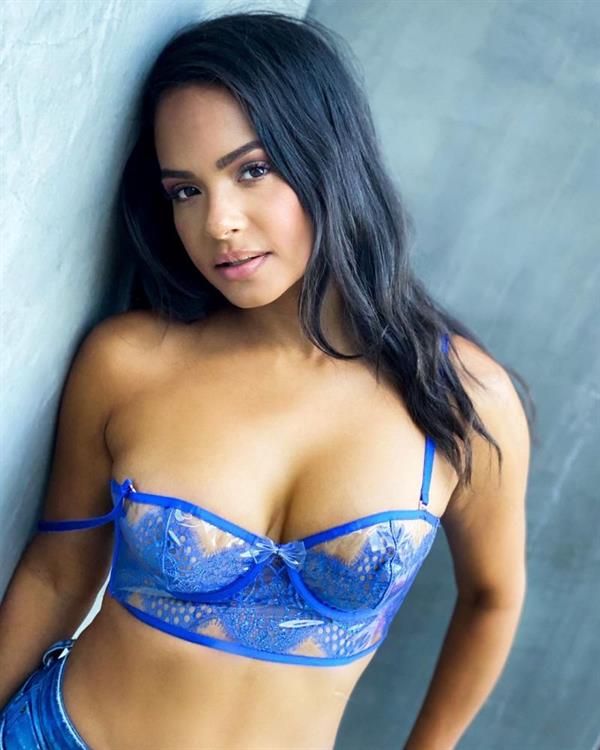 Christina Milian boobs showing nice cleavage with her big tits in a see through blue bra from a sexy new photoshoot.