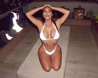 Kim Kardashian boobs showing nice cleavage with her big tits in a sexy white thong bikini on her knees in her closet.