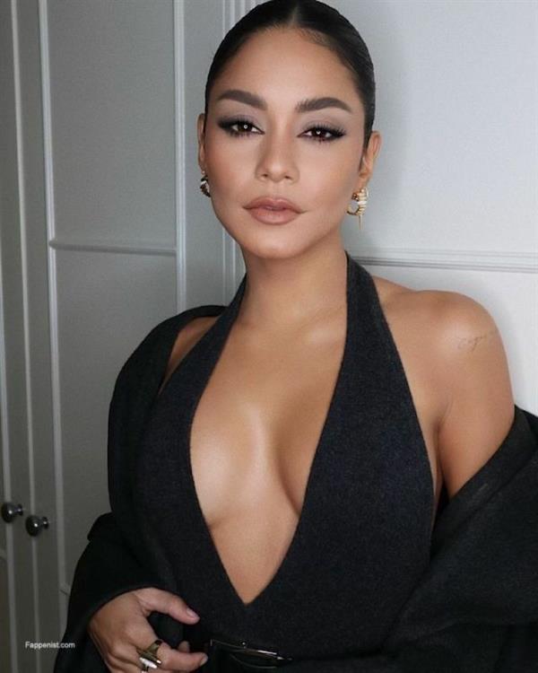 Vanessa Hudgens braless boobs showing nice cleavage with her famous big tits in a very low cut sexy black dress.