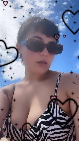 Rebekah Liepa taking a selfie in a zebra-pattern bikini.