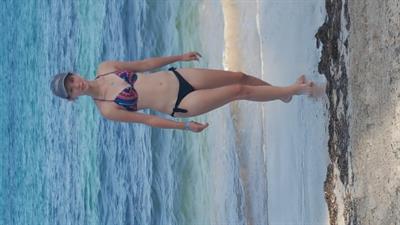 Liv in a bikini taking a selfie