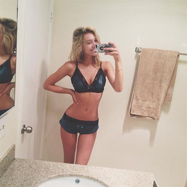 Alexis Ren in a bikini taking a selfie